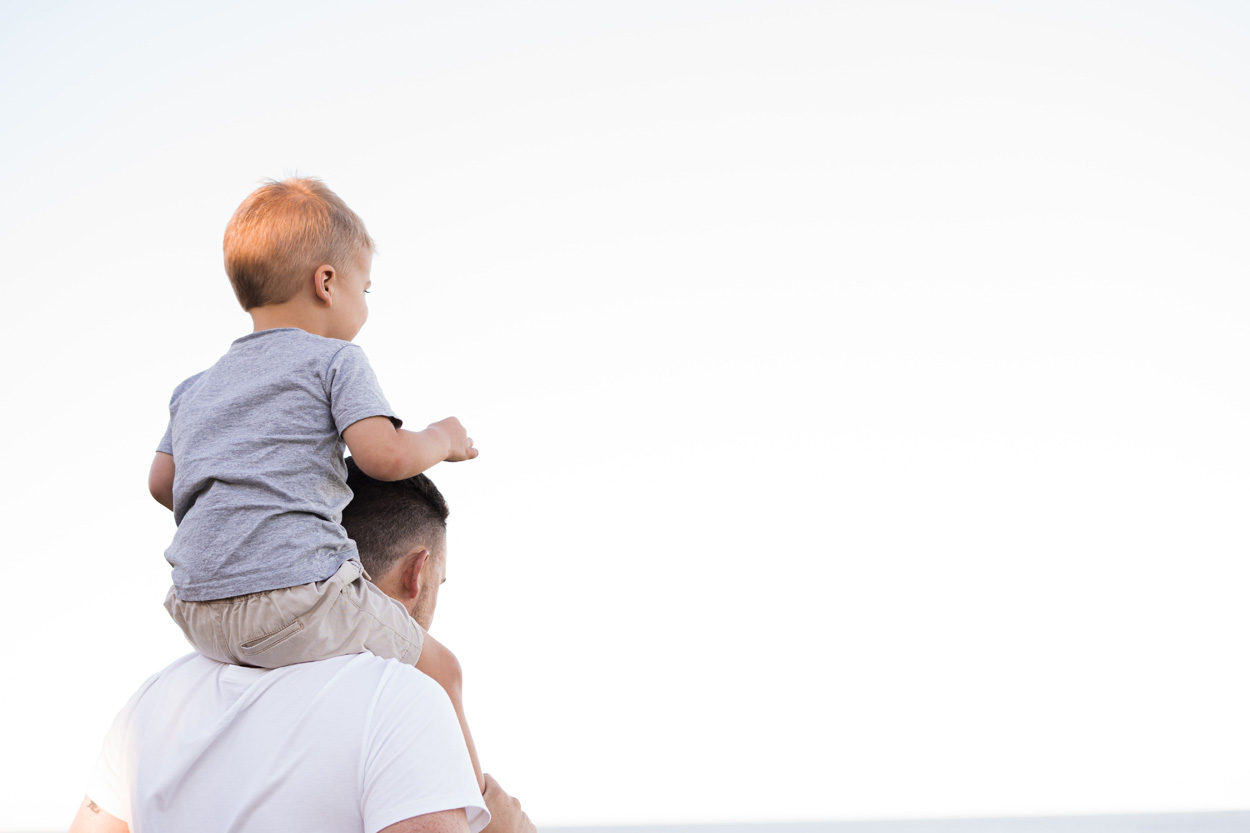 man in white t-shirt carrying boy