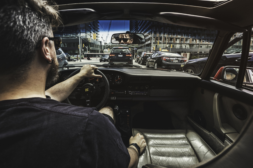 man driving a car in traffic