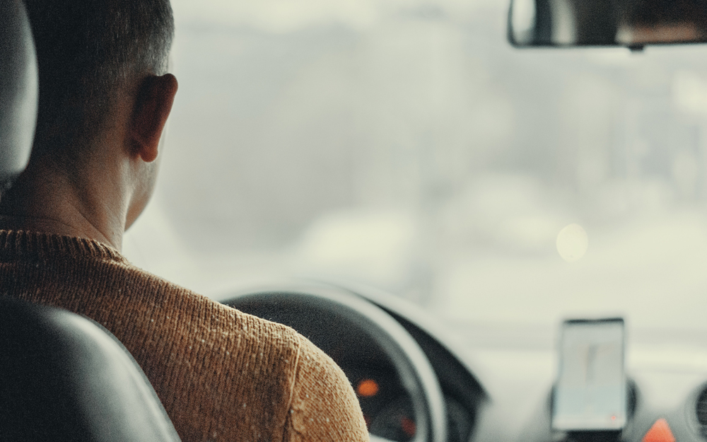 man behind the wheel driving vehicle