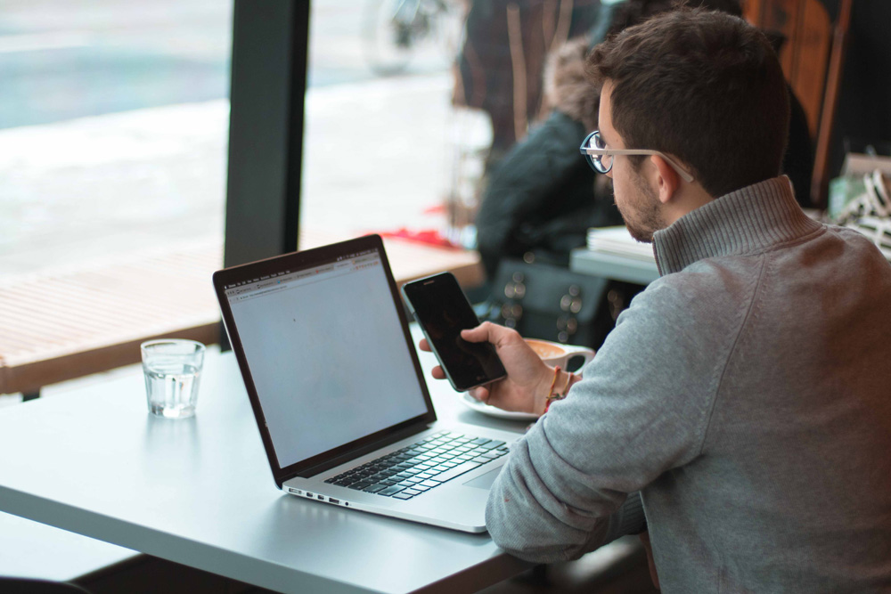 man working on laptop in a restaurant