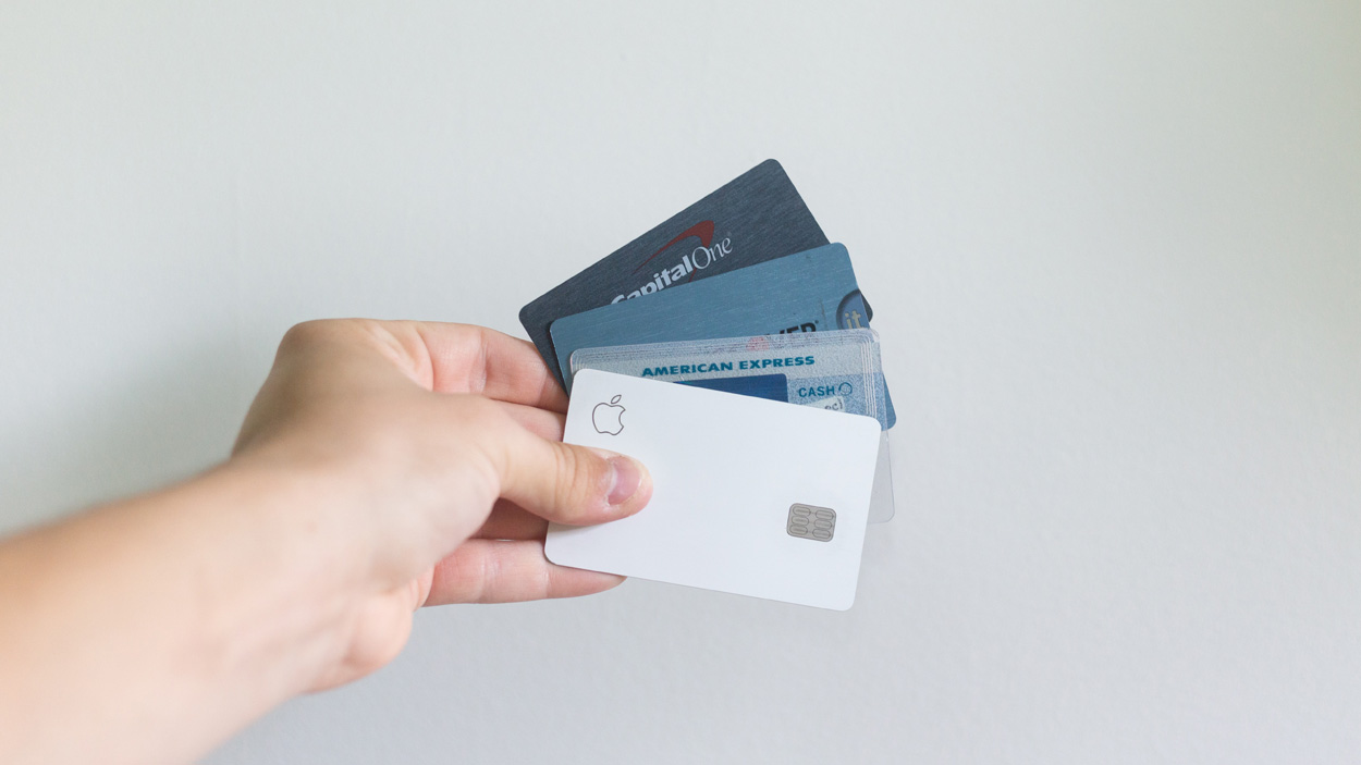 person holding credit cards