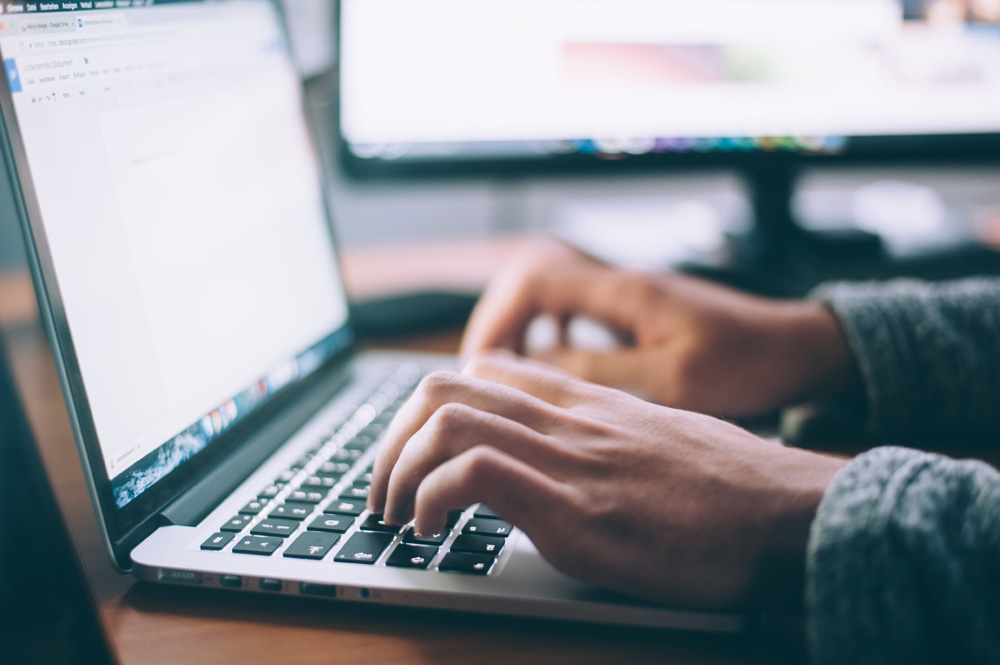 person using laptop at desk