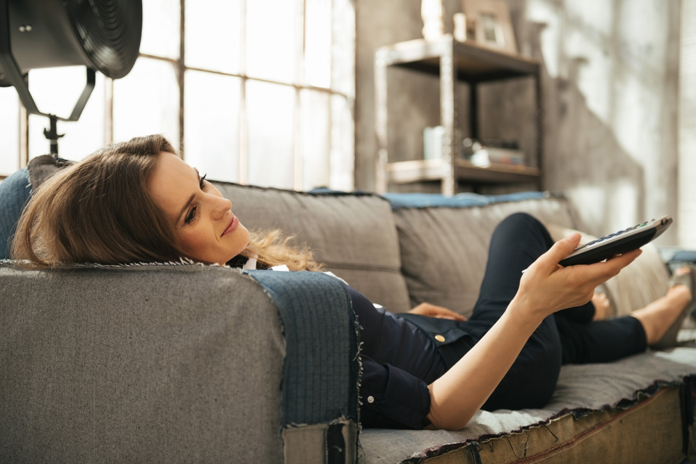 woman watching tv on the couch