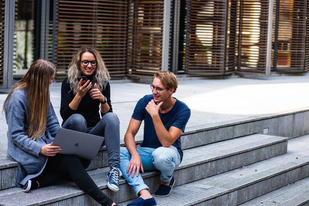 young adults chatting on steps outside